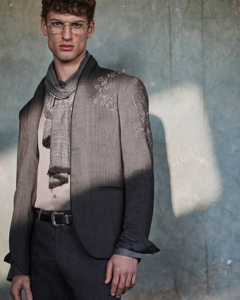 David Trulik wears the Bissell jacket with glasses and a loosely draped scarf for John Varvatos' fall-winter 2026 campaign