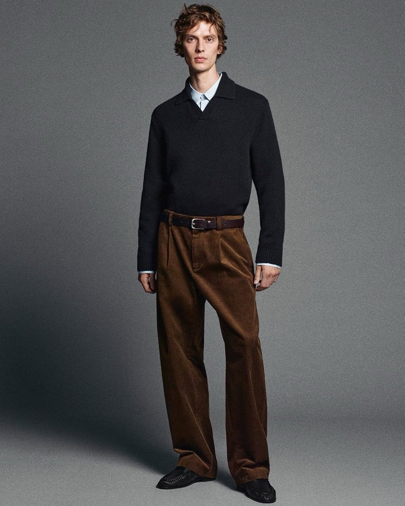 leon dame wears a cashmere polo sweater with corduroy trousers