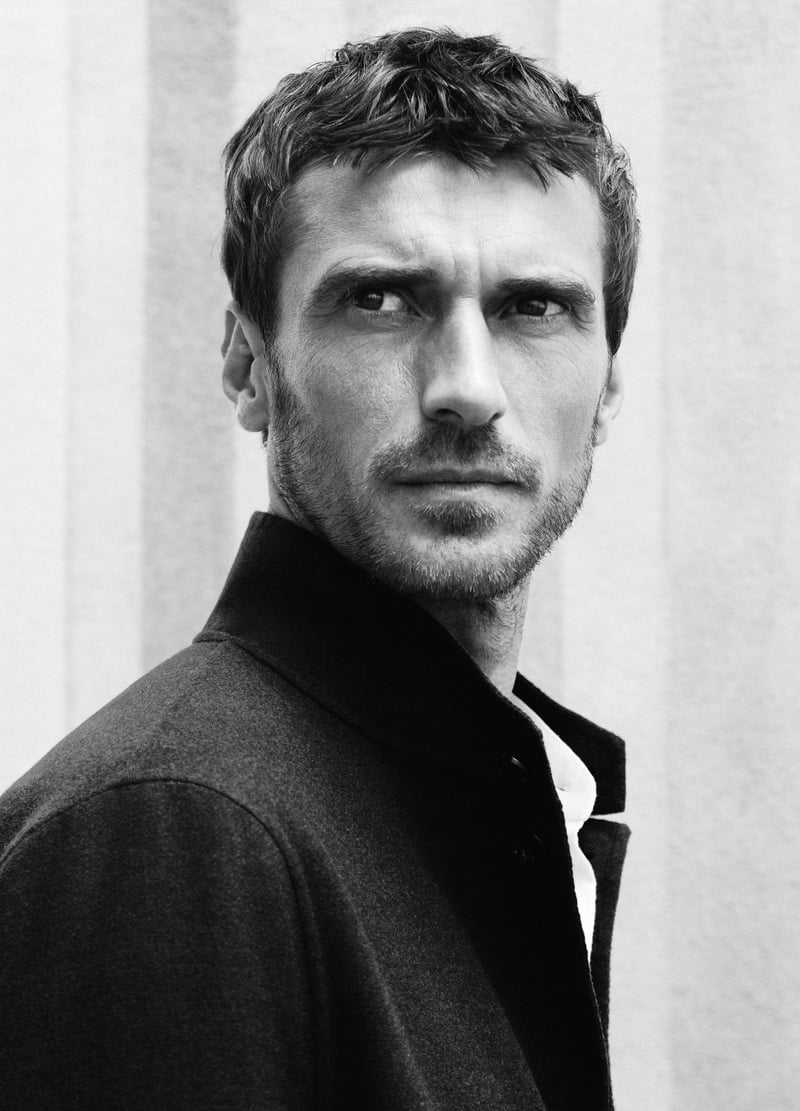 Clément Chabernaud wears a dark raised-collar blazer in a black-and-white portrait.