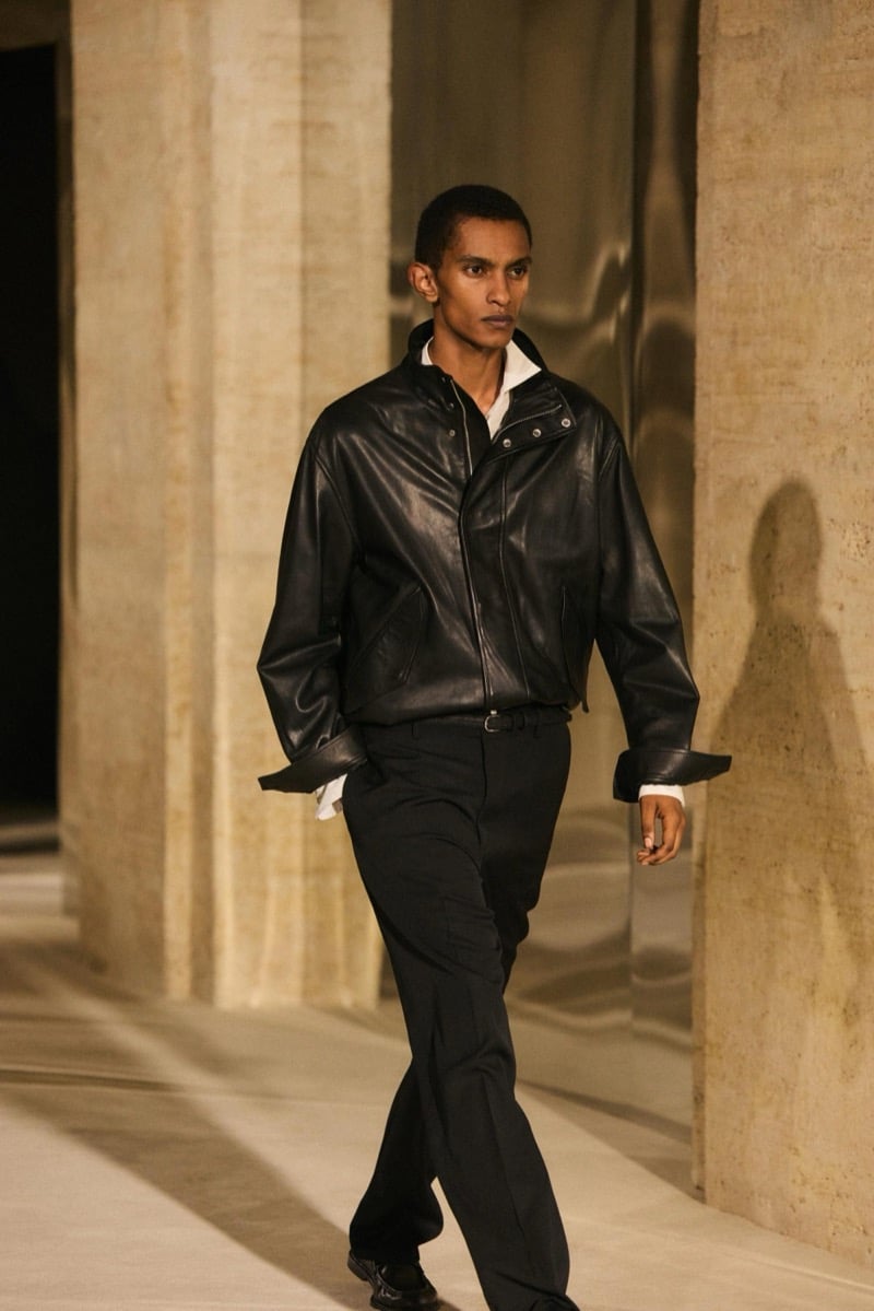 Massimo Dutti Limited Edition fall-winter 2026: Model wears a black leather blouson over a white shirt with black trousers.