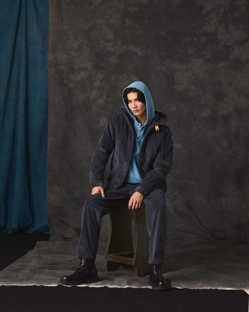 Model wears dark Parajumpers corduroy separates with a blue hoodie and black boots.