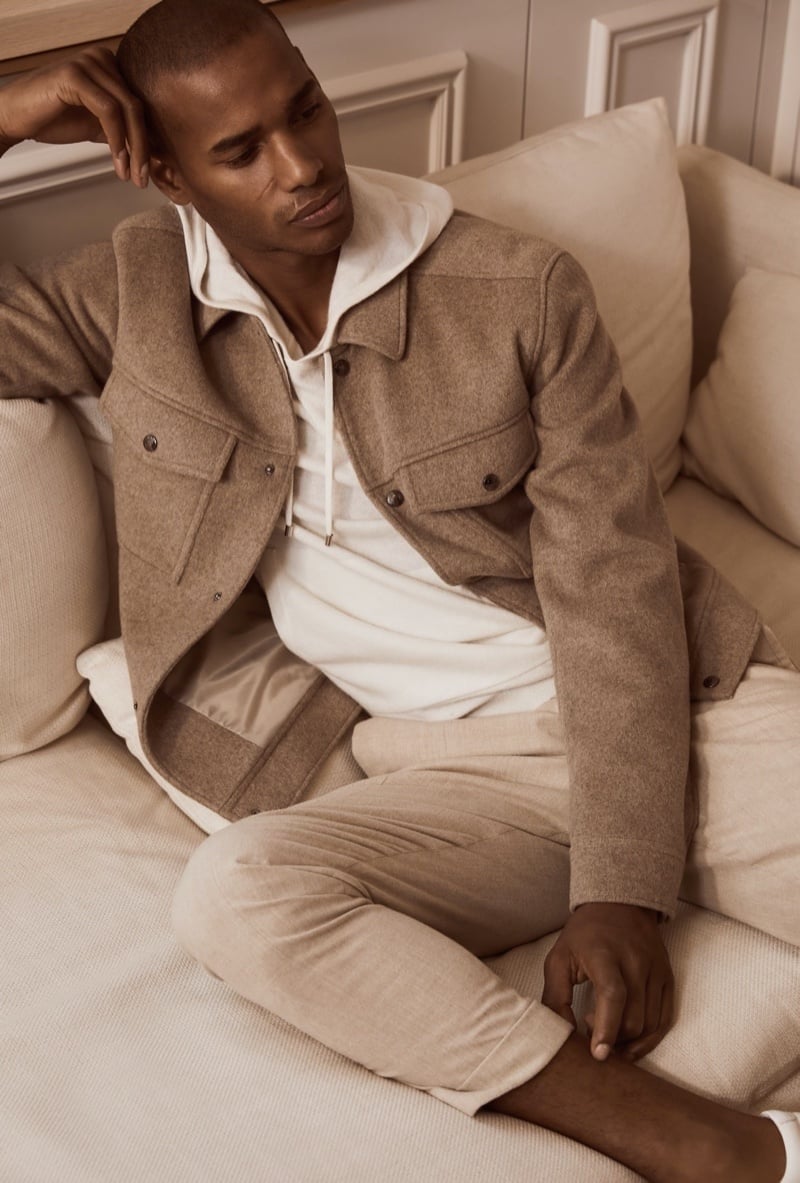 Sacha M’Baye wears a hoodie beneath a soft jacket in Reiss’ fall 2020 collection, joining lounge clothing to a more structured outer layer.