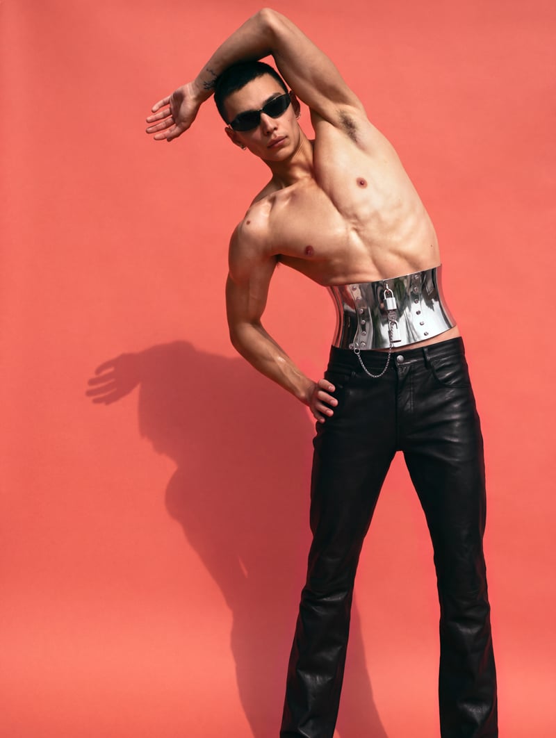 Sasha Profatilov wears a Dolce & Gabbana corset belt, Ann Demeulemeester trousers, Saint Laurent by Anthony Vaccarello sunglasses, and his own earrings.
