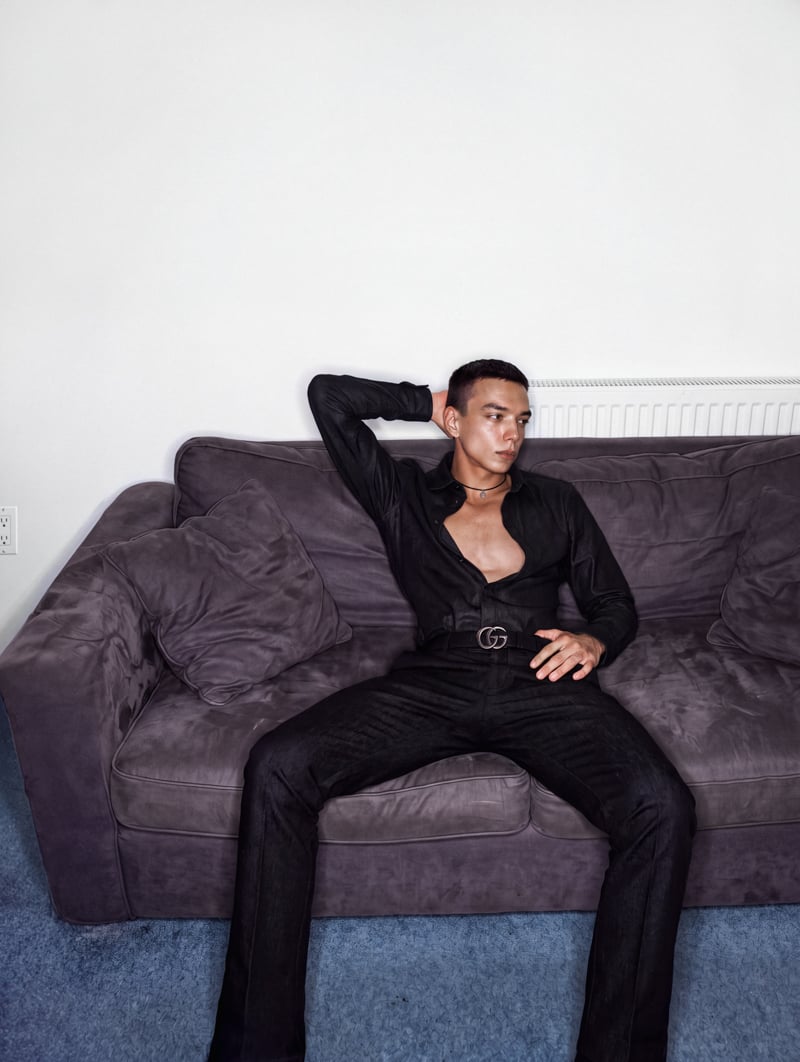 Sasha Profatilov reclines on a sofa in a Gucci look.