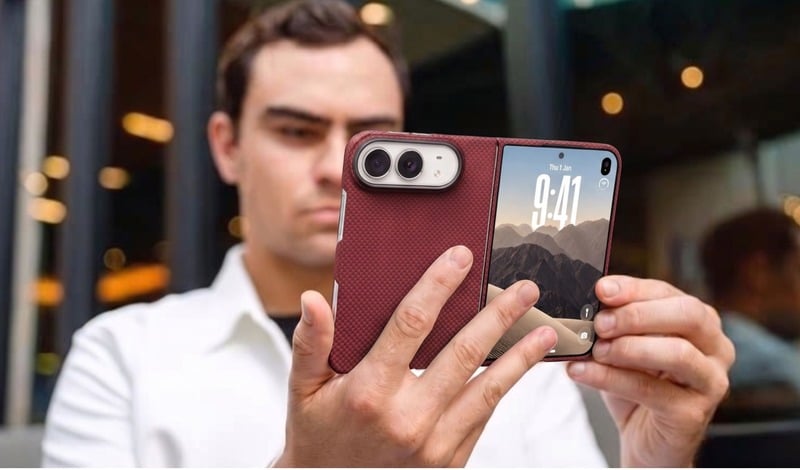 Man in a white shirt holding a phone with a crimson woven case.