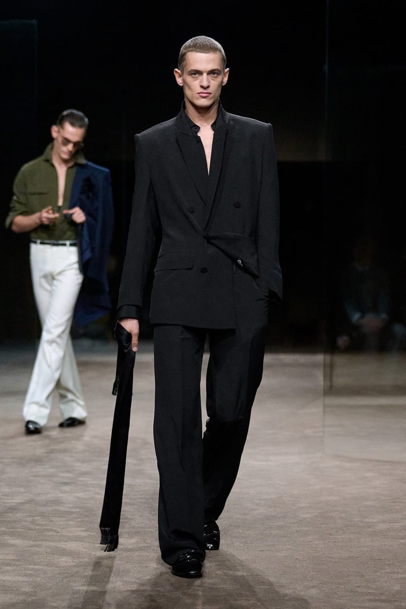 A model wears black suit with an open neckline on the Tom Ford spring-summer 2027 runway.
