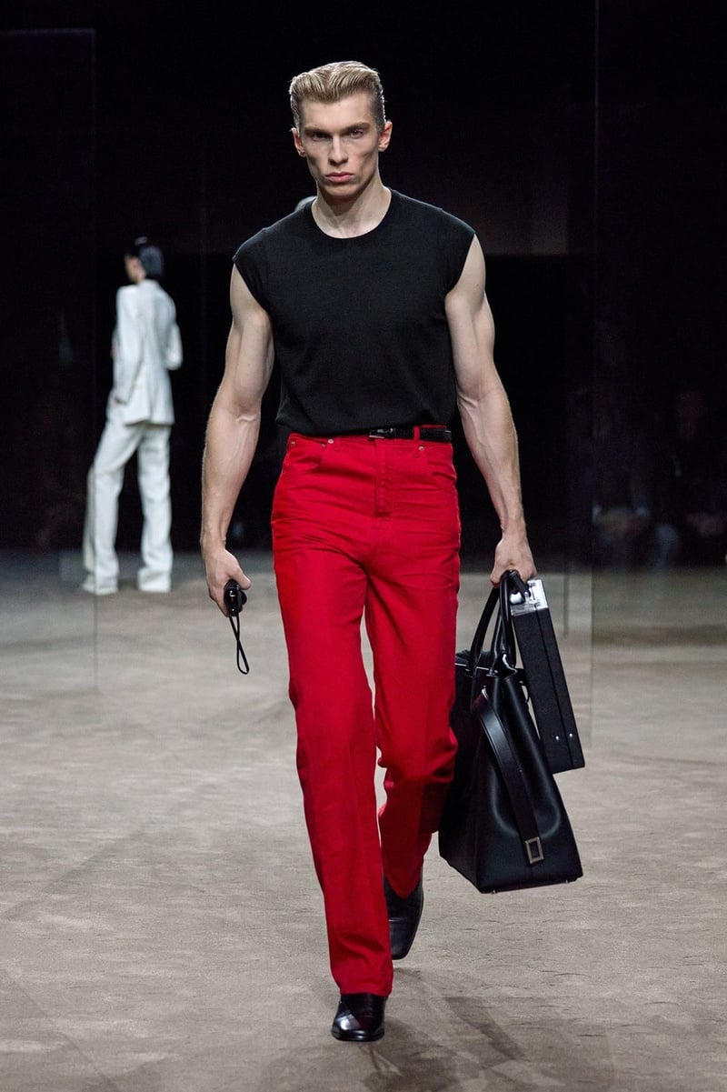 A model wears sleeveless black top with red trousers on the Tom Ford spring-summer 2027 runway.