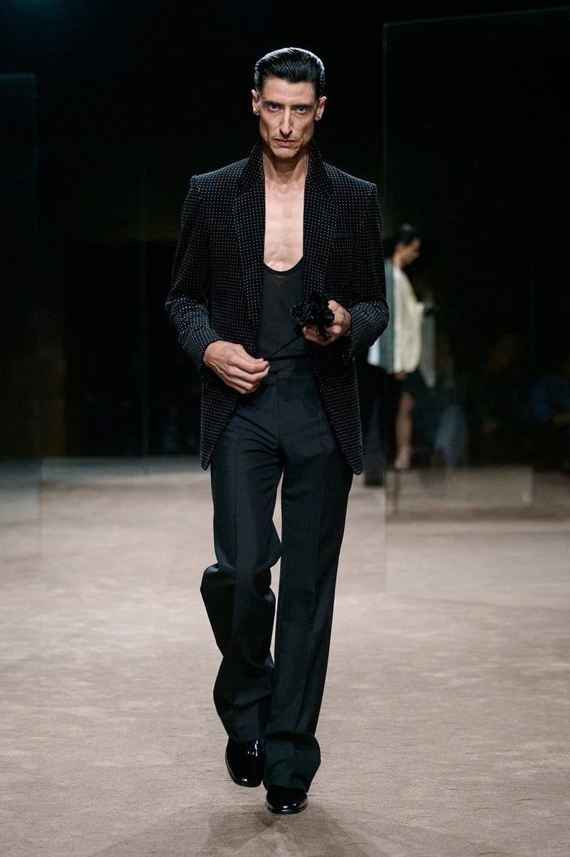 A model wears black tailoring with a low-cut top on the Tom Ford spring-summer 2027 runway.