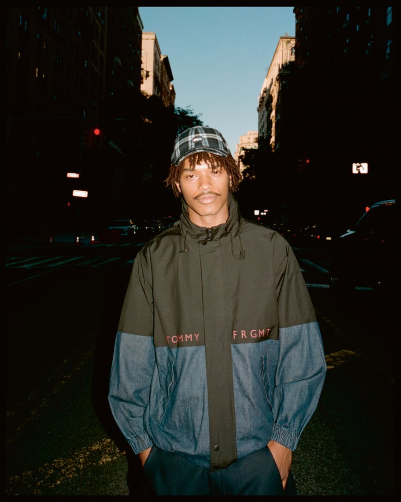 Nile Winchester wears a color-block Tommy Hilfiger x FRGMT jacket with a plaid cap.