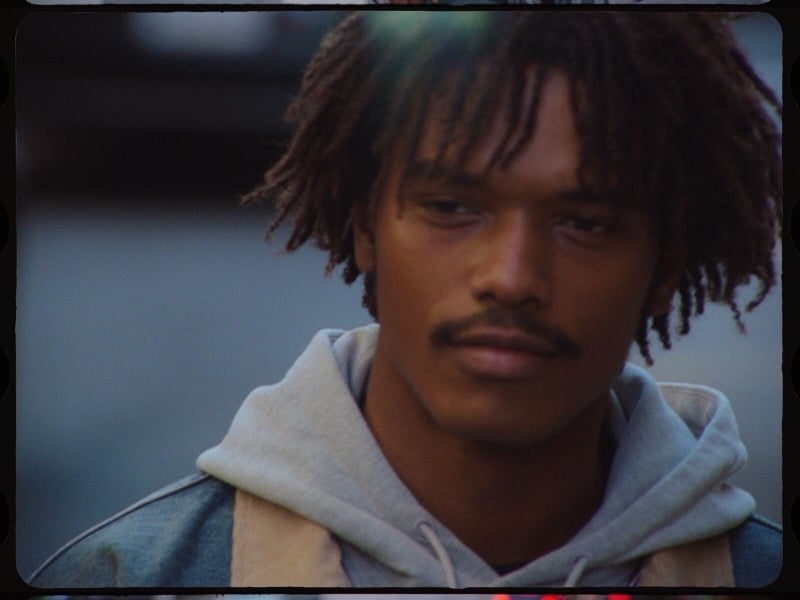 Close-up of Nile Winchester wearing a gray hoodie and denim jacket.