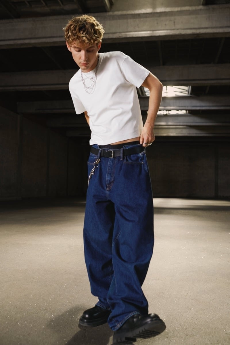Troye Sivan wears a cropped white tee and baggy jeans in Gap’s fall 2024 Get Loose campaign.