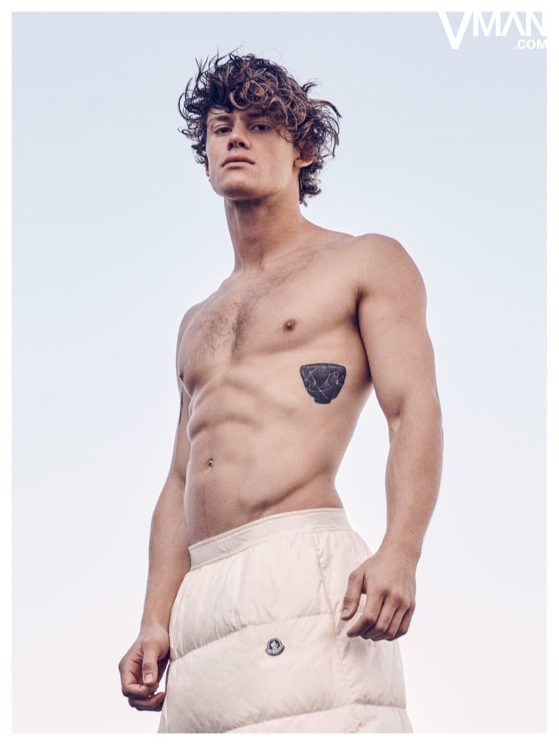 Lucas Pinheiro Braathen poses shirtless in light-colored Moncler trousers.