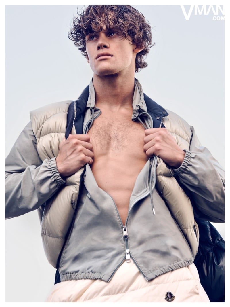 Lucas Pinheiro Braathen holds open a light-colored Moncler puffer jacket.