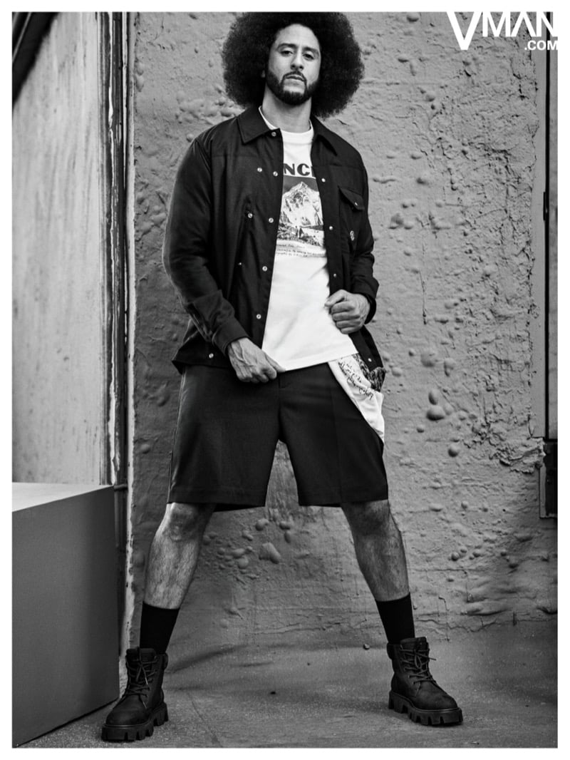 Colin Kaepernick wears a dark Moncler jacket, graphic T-shirt, shorts, and tall boots in black and white.
