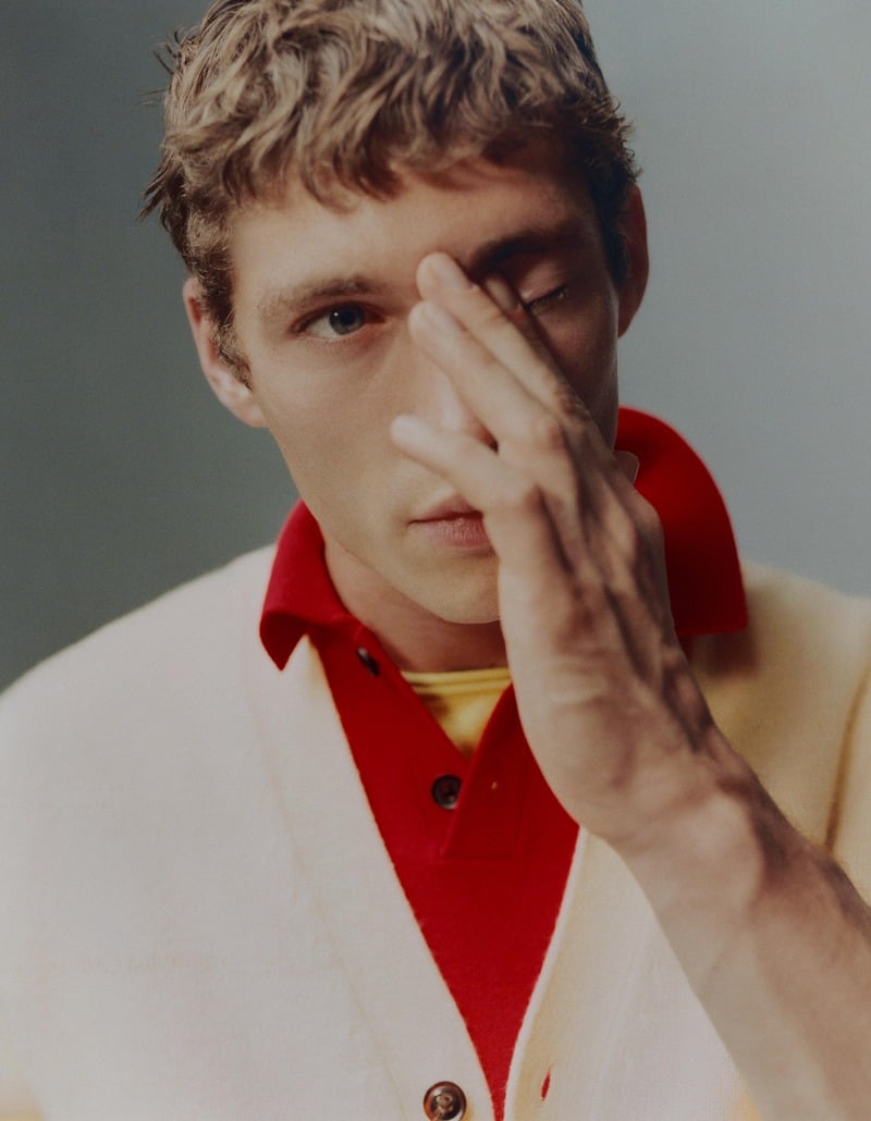 Valentin Humbroich wears a cream cardigan over a red polo and yellow layer in Zara's Color Coded fall edit.