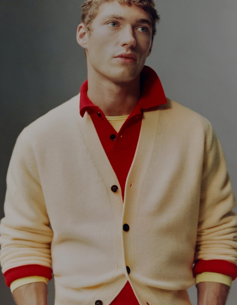 Valentin Humbroich wears a cream cardigan with a red polo and yellow cuffs.