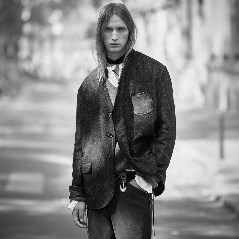Jesse Rinderknecht wears a textured jacket with a contrasting chest pocket over layered shirts for Zara Studio's fall-winter 2026 campaign