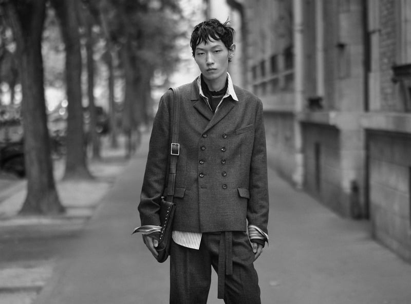 Li Cheng Yuan wears a double-breasted jacket over layered shirts with relaxed trousers for Zara Studio's fall-winter 2026 campaign