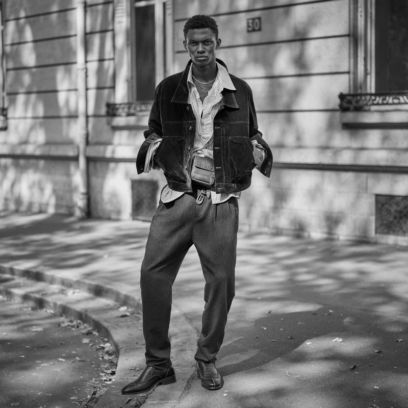 Rouna Obigba wears a contrast-collar jacket over layered shirts with loose trousers for Zara Studio's fall-winter 2026 campaign