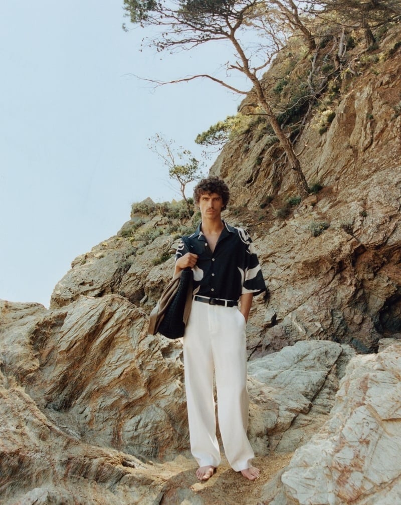 Grzegorz Chanko wears wide white trousers with a printed shirt in Zara’s summer 2024 edit.